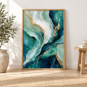 May include: A rectangular wall art print in a light wood frame featuring an abstract fluid painting with swirling layers of deep teal, emerald green, mint, and white, accented by metallic gold veins and speckles throughout the composition.