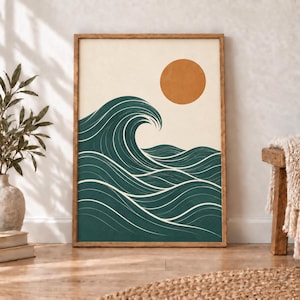 May include: A rectangular wall art print in a wooden frame featuring a stylized graphic of a large dark teal ocean wave with white line details against a cream background, topped with a solid burnt orange circle representing the sun.