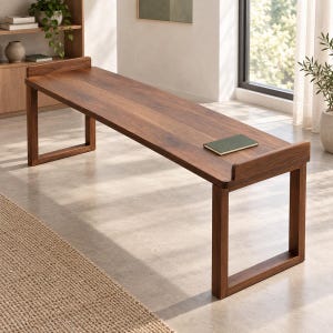 May include: A long, rectangular wooden bench crafted from dark brown wood with a smooth, polished surface. The bench features two sturdy, open-frame rectangular legs at each end and small, curved backrests extending upward from the seat edges.