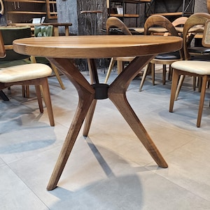 Real showroom photograph proving the black central collar and radial walnut arm construction