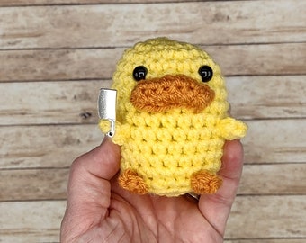 Crocheted mini duck with knife, stuffed animal, plushie