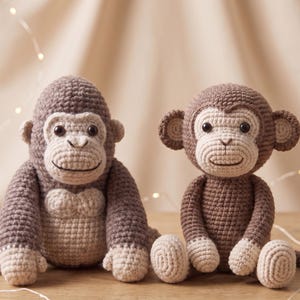 May include: Two handmade crochet stuffed animals, a gorilla and a monkey. The gorilla is dark brown with a light beige face, chest, and hands. The monkey is a lighter brown with a beige face, ears, hands, and feet, featuring a long tail.