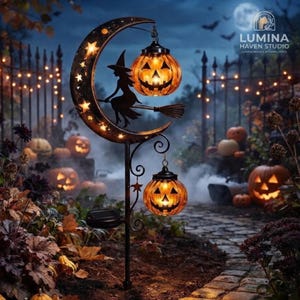 May include: A black metal garden stake featuring a crescent moon silhouette with star cutouts, a witch on a broomstick, and two hanging orange jack-o'-lantern lights. The stake includes a solar panel and is set in a dark outdoor garden.