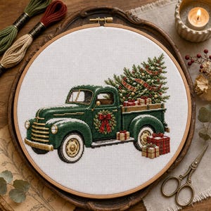 Può includere: Un progetto di ricamo a punto croce in un telaio rotondo in legno raffigurante un pick-up vintage verde che trasporta un albero di Natale decorato. Il camion ha una ghirlanda rossa sulla portiera e diversi pacchetti regalo nel cassone.
