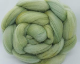 May include: A close-up of a bundle of green and yellow wool roving, labeled "Aloe Vera".