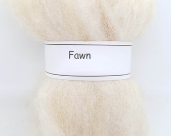May include: A close-up of a bundle of cream-colored wool roving with a label that reads "Fawn".