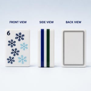 May include: A white rectangular mahjong tile showing a front view with the number 6 and six blue and light blue snowflake icons, a side view with one blue and one green vertical stripe, and a back view with a simple double-lined border.