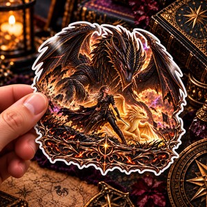May include: A die-cut sticker featuring a dark, scaled dragon with expansive wings looming over a warrior in black armor and a smaller, golden-scaled dragon. The scene is set against a fiery, orange-toned background with an ornate, metallic-style border.