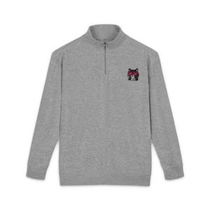 May include: A heather grey long-sleeve quarter-zip sweatshirt featuring a small embroidered graphic on the left chest. The graphic depicts a black cat wearing bright pink heart-shaped sunglasses. The garment has a stand-up collar and a metal zip.