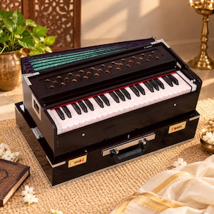 May include: A dark brown wooden harmonium featuring a keyboard with white and black keys, a bellows section with a green patterned fabric, and a base case equipped with two gold-coloured combination locks and a central black carrying handle.