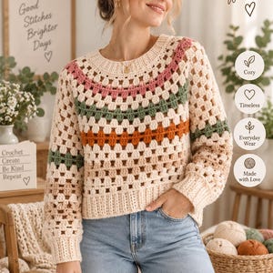 Puede incluir: Un suéter de ganchillo de manga larga con un patrón de punto granny en crema, rosa, verde y naranja. El jersey tiene un cuello redondo y puños acanalados. El texto incluye BabyPurl Co, Handmade Style for a Kinder World y Granny Stitch Crochet Sweater Modern Relaxed Pullover con tallas XS, S, M, L, XL, 2XL.