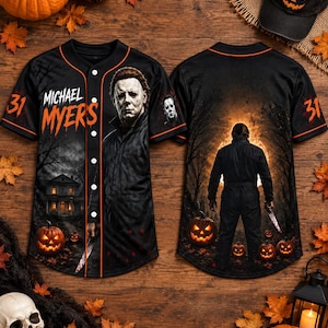 May include: A black button-down baseball jersey featuring a graphic of Michael Myers, the text "MICHAEL MYERS", and the number "31". The design includes a house, pumpkins, and a forest scene. The back shows a figure holding a knife.