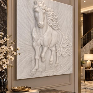 May include: A square white wall art piece featuring a high-relief sculpture of a horse in motion. The horse is depicted with a flowing mane and tail, carved from a smooth, light-coloured material that creates a three-dimensional effect on the surface.