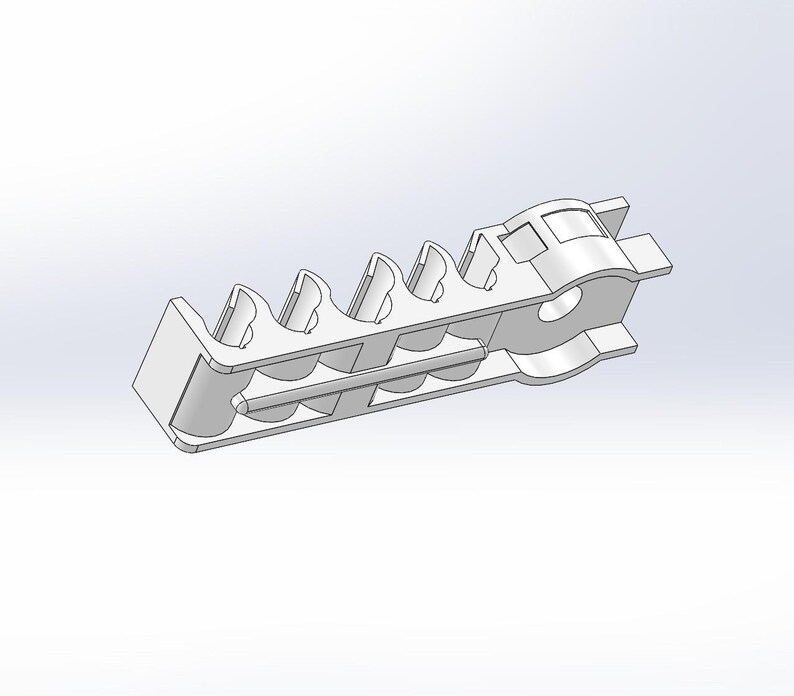 May include: A white, elongated, rigid plastic component featuring a series of five evenly spaced, curved, open-top slots along its length, with a circular aperture at one end and a small, protruding tab at the opposite end of the structure.