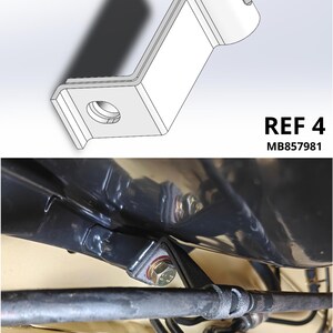 May include: A silver metal Z-shaped mounting bracket with a circular hole at one end and a curved pipe-holding section at the other, labeled REF 4 MB857981. The bracket is shown installed, securing a black pipe to a vehicle chassis component.