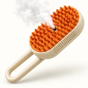 May include: An oval-shaped grooming brush with a beige handle and body, featuring an orange silicone bristle pad. A small central nozzle emits a visible plume of steam. The device has a series of thin vertical vents along the side of the casing.