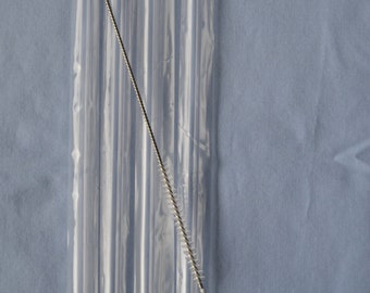 May include: A package of clear, reusable drinking straws. The straws are made of a transparent material and are packaged in a clear plastic sleeve. A stainless steel cleaning brush is included. The brush has a looped handle and bristles.