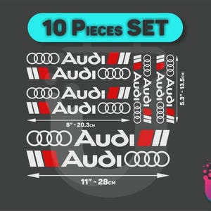 Peut inclure: Un ensemble de 10 autocollants en vinyle Audi comprenant le logo de la marque, du texte et des bandes rouges, blanches et noires. Le lot inclut diverses tailles, avec des dimensions indiquées de 8 pouces pour 20,3 cm et 11 pouces pour 28 cm, et 5,3 pouces pour 13,5 cm.