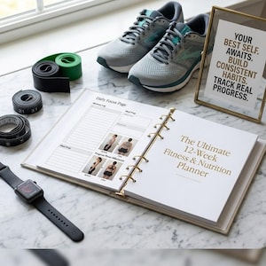 May include: A fitness and nutrition planner open to a page titled The Ultimate 12-Week Fitness & Nutrition Planner, accompanied by grey athletic shoes, a black smartwatch, two measuring tapes, green and black resistance bands, and a framed sign.
