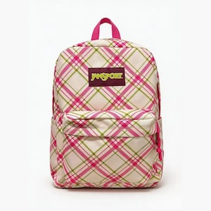 May include: A JanSport backpack featuring a cream-colored base with a diagonal plaid pattern in bright pink and olive green. The bag includes a top handle, a front zippered pocket, and a rectangular maroon patch with the yellow text JanSport.