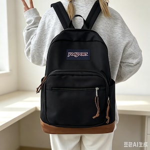 May include: A black backpack with a brown base and a JanSport logo patch on the front. The bag features a large main compartment, a smaller front zippered pocket with brown cord zipper pulls, and two adjustable black shoulder straps for carrying.