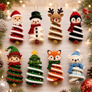 May include: Eight crocheted Christmas ornaments featuring Santa Claus, a snowman, a reindeer, a penguin, an elf, a Christmas tree, a fox, and a polar bear. Each figure has a spiral-shaped body with a small metallic bell attached to the bottom.