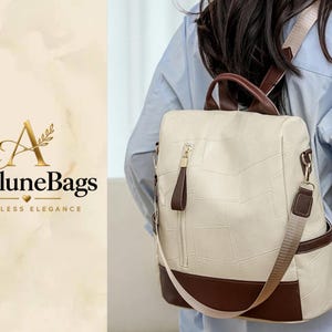 May include: A cream-colored backpack with a textured, geometric pattern and dark brown trim. It features a vertical zippered front pocket with a brown pull tab, a top handle, and adjustable shoulder straps. The logo AveluneBags is visible.