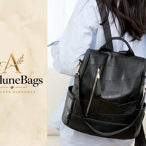 May include: A black backpack featuring a patchwork design with a vertical gold-toned zip on the front. The bag includes a top handle, adjustable shoulder straps, and side pockets. The text AveluneBags Timeless Elegance is displayed on the left.