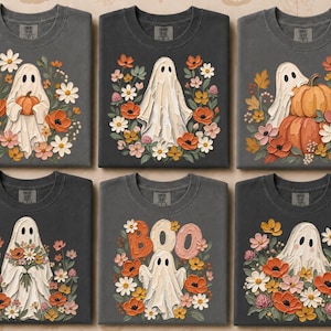 Peut inclure: Six t-shirts gris foncé présentant diverses illustrations de fantômes. Les motifs incluent des fantômes tenant des citrouilles, des bouquets de fleurs ou debout près du texte BOO. Chaque graphique est entouré de compositions florales aux tons orange, rose et blanc.