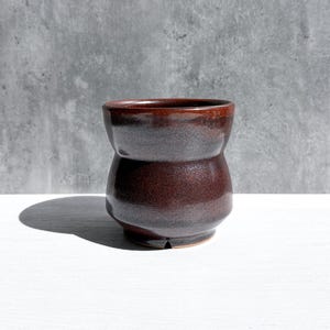 May include: A set of three ceramic nesting bowls in shades of blue, green, and white. The bowls feature a speckled glaze and a simple, modern design. The largest bowl measures approximately 6 inches in diameter.
