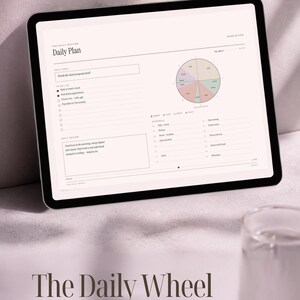 May include: A digital tablet displaying a Daily Plan template titled The Daily Rhythm. The screen features a daily goal section, a to-do list, a daily review box, and a circular pie chart divided into color-coded segments for work, life, rest, and play.