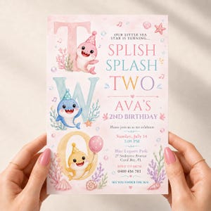 May include: A rectangular birthday invitation card with a light pink background featuring three cartoon sharks wearing party hats, coral, seashells, and bubbles. The text reads: Our little sea star is turning... Splish Splash Two Ava's 2nd Birthday.