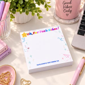 May include: A square notepad with white paper featuring a colorful header that reads Oh, For Fuck Sakes! and a footer that says YOU'RE DEFINITELY OVER THINKING THIS. The border is decorated with small blue, pink, and yellow star, heart, and paper plane icons.