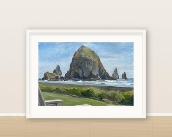 May include: A framed oil painting depicting a large, dark, jagged rock formation rising from the ocean near a sandy beach. The foreground features green coastal vegetation and a partial view of a wooden chair, all under a bright blue sky.