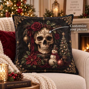 May include: A square black throw pillow featuring a central human skull adorned with red roses, holly, and pinecones. A small snowman in a top hat stands beside the skull, with a decorated Christmas tree, ornaments, and the text Customize your picture.
