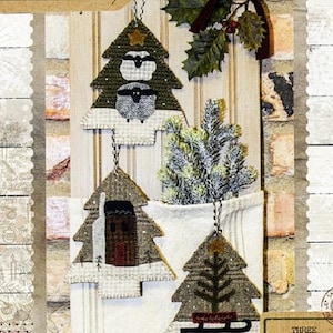 May include: Three felt Christmas ornaments in the shape of trees. The ornaments are decorated with a sheep, a house, and a sled. The ornaments are 5.5 inches by 6.5 inches.