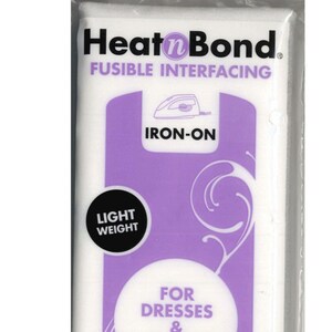 May include: A white package of Heat'n Bond fusible interfacing for dresses and blouses. It is light weight and iron-on. The package is 20 inches by 1 yard (50.8 cm x 91 cm) and made in the USA.