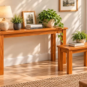 May include: A rectangular wooden console table and a matching smaller wooden side table, both featuring a warm brown finish, straight legs, and a slatted top design. The furniture pieces are constructed from wood with a visible grain pattern.