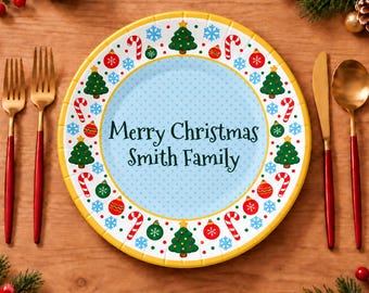 May include: A round plate with a light blue center featuring the text Merry Christmas Smith Family. The border displays a pattern of green Christmas trees, red and green ornaments, candy canes, and blue snowflakes on a white background.