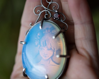 Persephone with Skulls and Flowers in Her Hair, Trapped Behind an Opalite Window. Sterling Silver with Garnet, Filigree Scrollwork Pendant