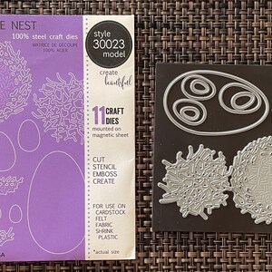 May include: A set of 11 steel craft dies for creating delicate nest designs. The set includes various nest shapes and egg outlines, perfect for cutting, stenciling, embossing, and creating. The package is purple and includes the text "DELICATE NEST".