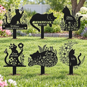 May include: Six black metal garden stakes featuring cat silhouettes with floral and butterfly cutouts. Each stake displays personalized names like Willow, Catnames, Chloe, Coco, Lucy, and Lily, along with dates and phrases like Forever in our heart.