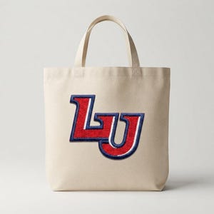 May include: A beige canvas tote bag featuring a large, embroidered patch on the front. The patch displays the letters LU in a bold, collegiate-style font with a textured red fill, a white outline, and a thick navy blue border.
