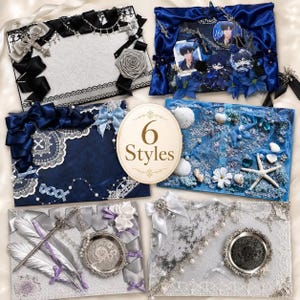 May include: Six rectangular display boards featuring diverse decorative themes including black and silver ribbons with crosses, blue satin with character badges, dark blue lace, ocean-themed shells and starfish, silver feathers, and lace with pearls.