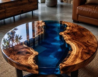 May include: A round coffee table featuring a natural wood slab with a live edge and a glossy finish. A central river-like inlay of translucent deep blue resin runs through the middle of the wood. The table is supported by a black metal base.
