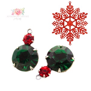 May include: Two green and red crystal jewelry components with silver-tone settings. A red glitter snowflake is also shown. The jewelry components have a large green round crystal with a smaller red crystal attached. The text "ALYSSABETHS VINTAGE jewelry supply" is in the upper left corner.