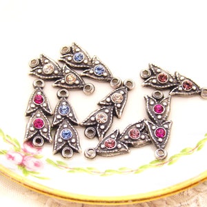 May include: Assortment of silver-toned metal pendant charms with crystal embellishments. Each charm features a teardrop shape with three rows of crystals in various colors, including pink, blue, and clear.