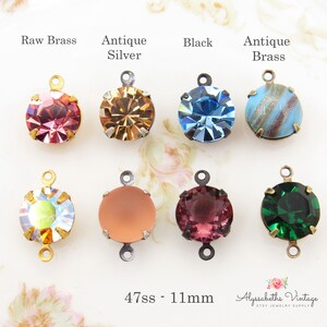 May include: Assortment of 11mm round glass rhinestones with different colors and finishes. Each rhinestone is attached to a metal connector with a loop on each side. The connectors are available in raw brass, antique silver, black, and antique brass finishes. The text "47ss - 11mm" is visible at the bottom of the image.