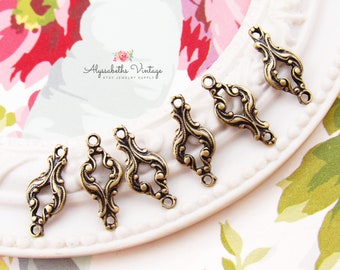 May include: Five antique gold-toned metal connector charms with a decorative, ornate design. Each charm has two loops for attaching to jewellery or other crafts.