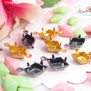 May include: Assorted vintage gold and silver metal settings for square cabochons. The settings have two loops on the side and one loop on the top. The settings are on a white surface with green and pink rhinestones.